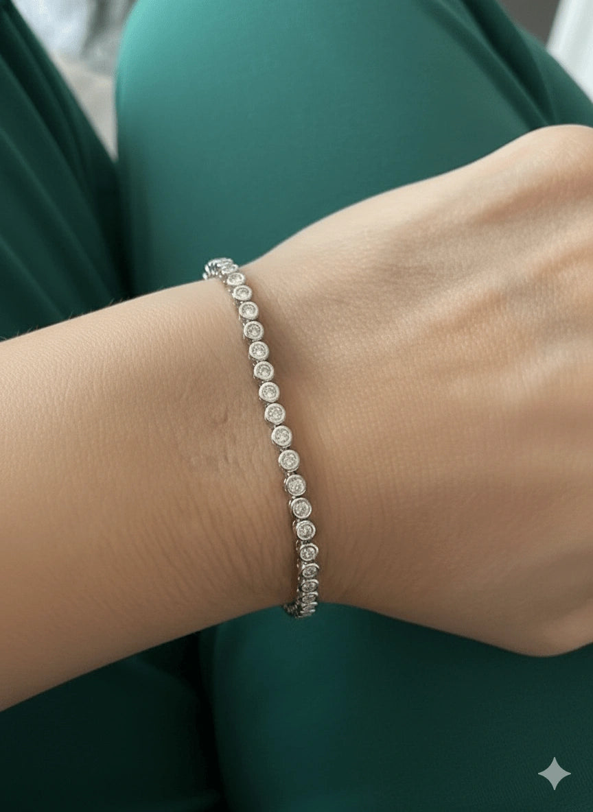 Bezel set moissanite tennis bracelet with 2mm D color VVS1 stones in 925 sterling silver worn on wrist - Sensitive Stones
