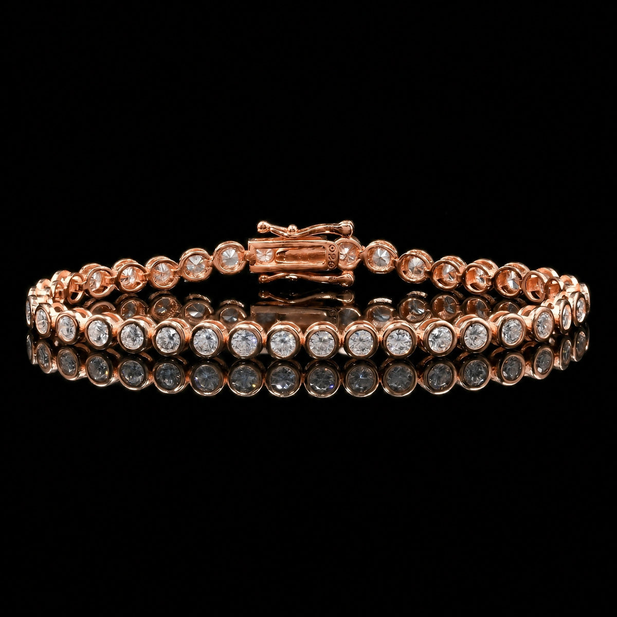 Bezel moissanite tennis bracelet with D color VVS1 stones in 925 sterling silver and rose gold finish, illuminated against a black background with reflective surface to show fire and brilliance - Sensitive Stones