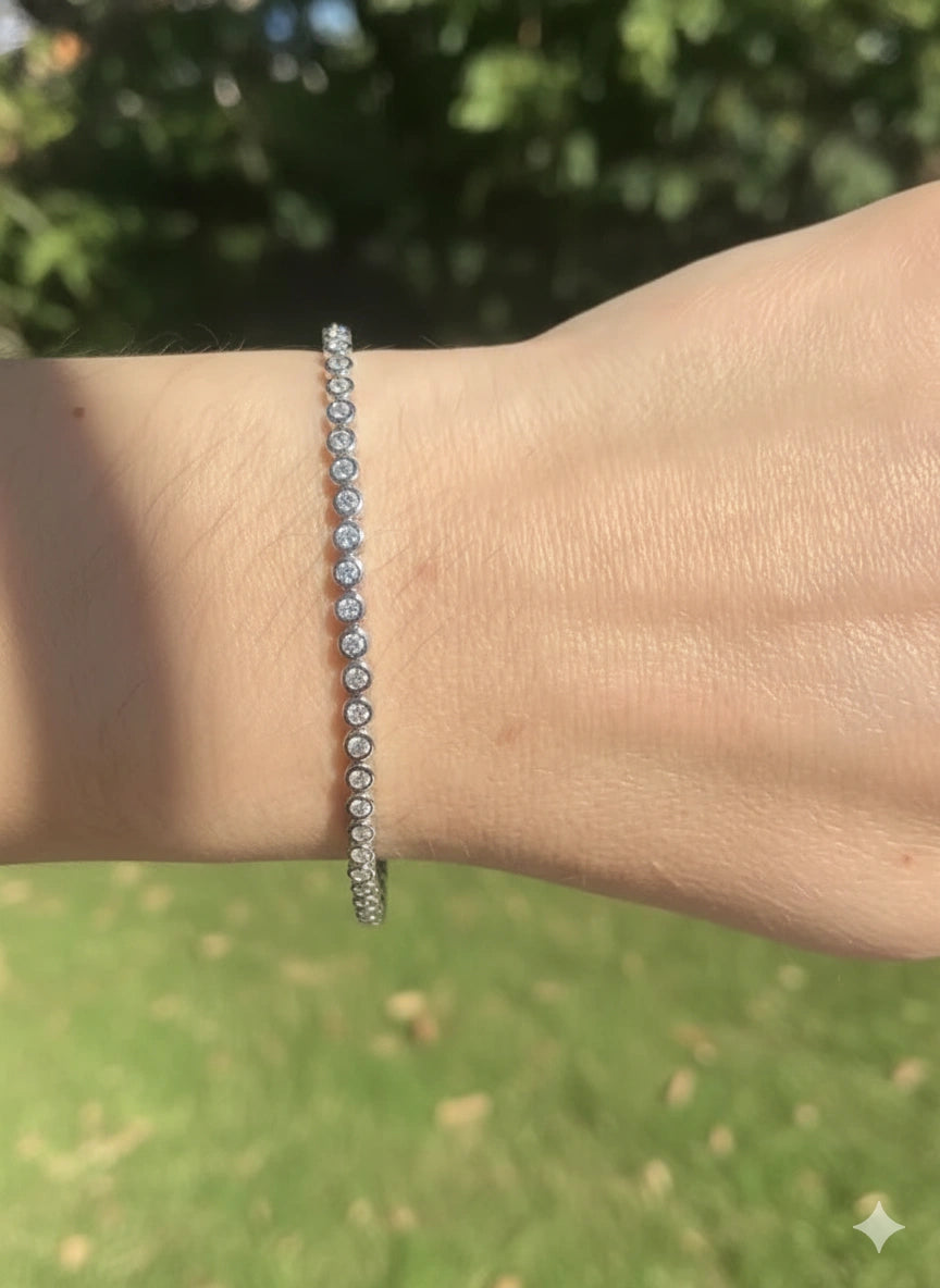 Slim bezel moissanite tennis bracelet with 2mm D color VVS1 stones in 925 sterling silver, sparkling in natural sunlight and showing full row of fire - Sensitive Stones