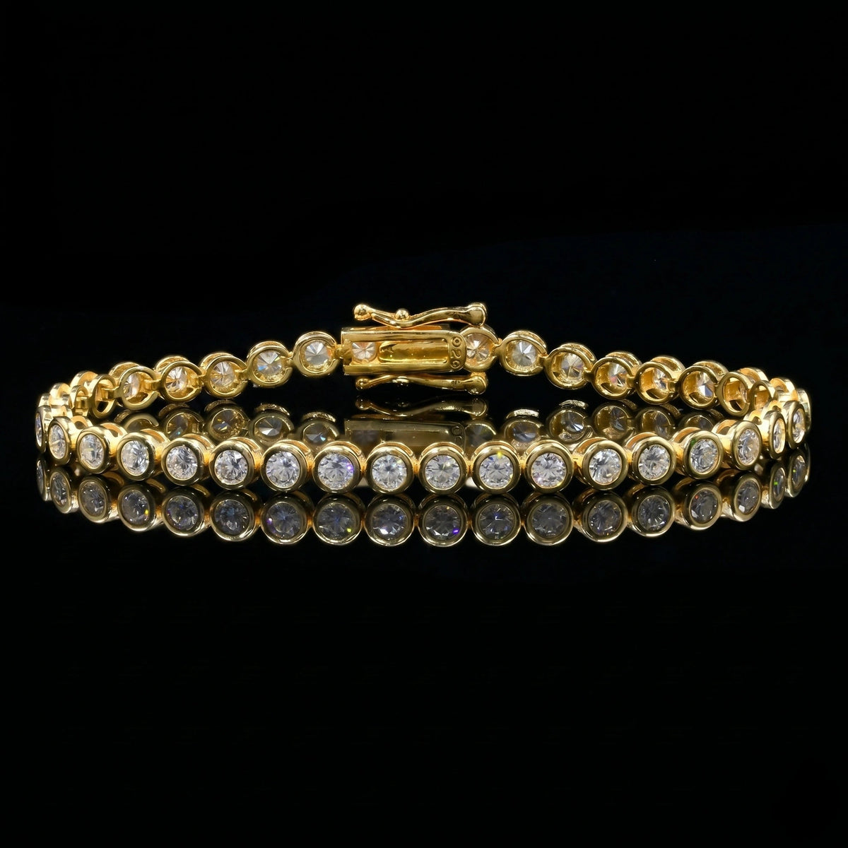 Bezel moissanite tennis bracelet with D color VVS1 stones in 925 sterling silver and 18k yellow gold finish, illuminated against a black background with reflective surface to show fire and brilliance - Sensitive Stones