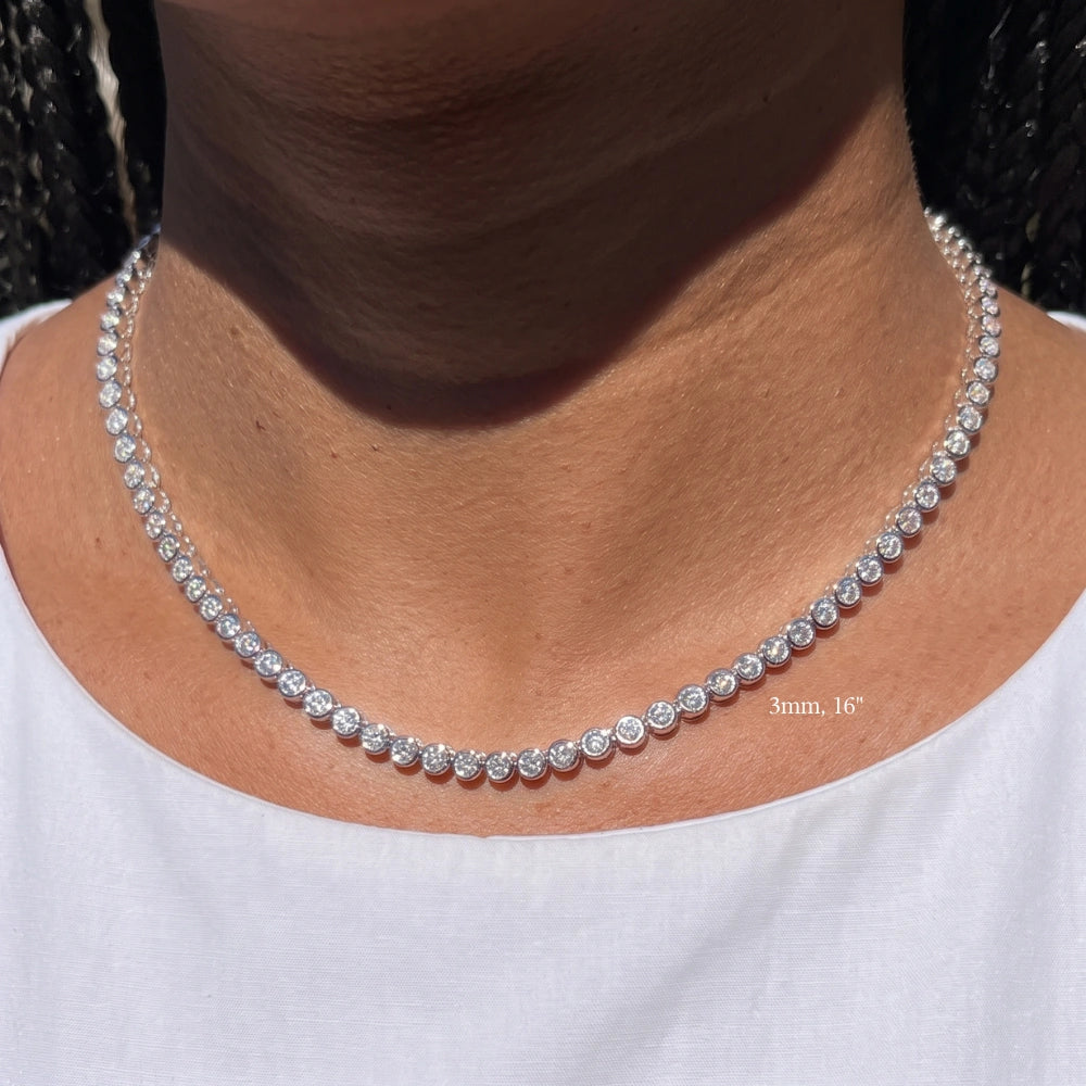 Bezel moissanite tennis necklace with 3mm stones at 16in worn on the neck resting at the collarbone
