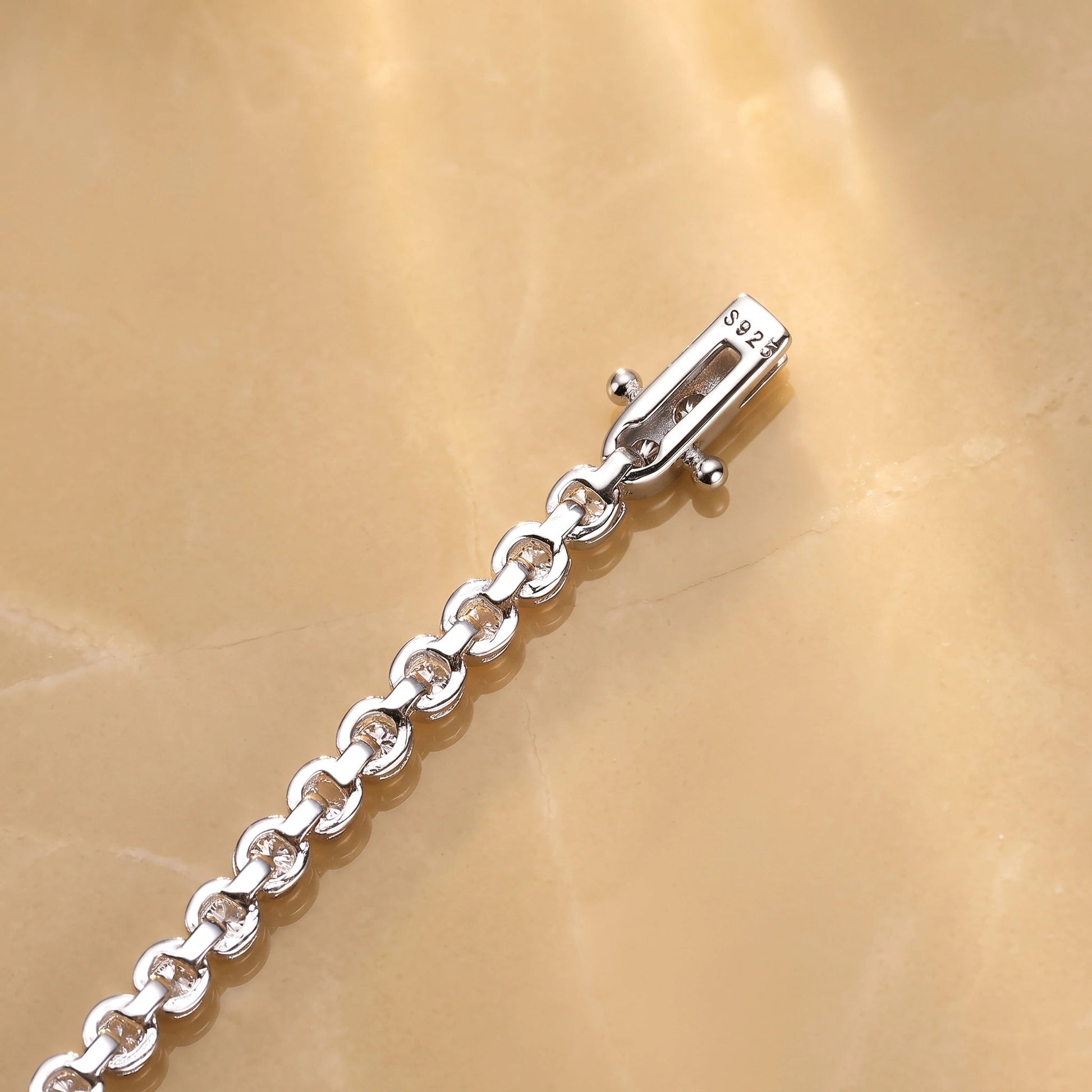 Underside of a bezel moissanite tennis necklace clasp showing the S925 sterling silver stamp