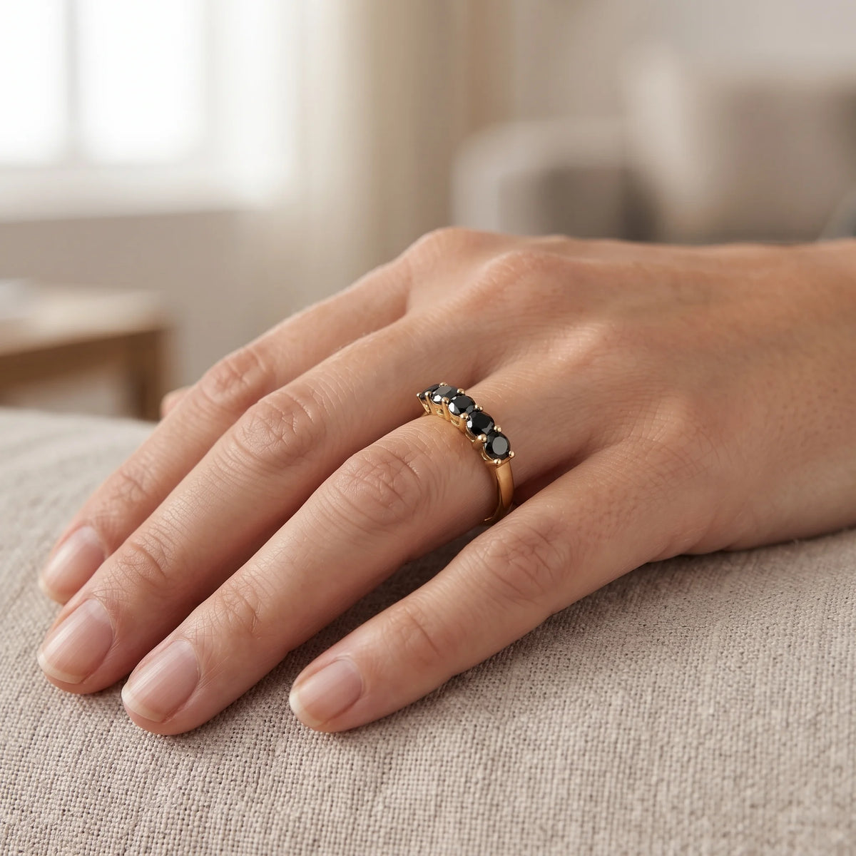 Black moissanite five stone stackable ring in 14K gold filled worn on a hand, five 3.5mm black stones in a close row across the finger - Sensitive Stones