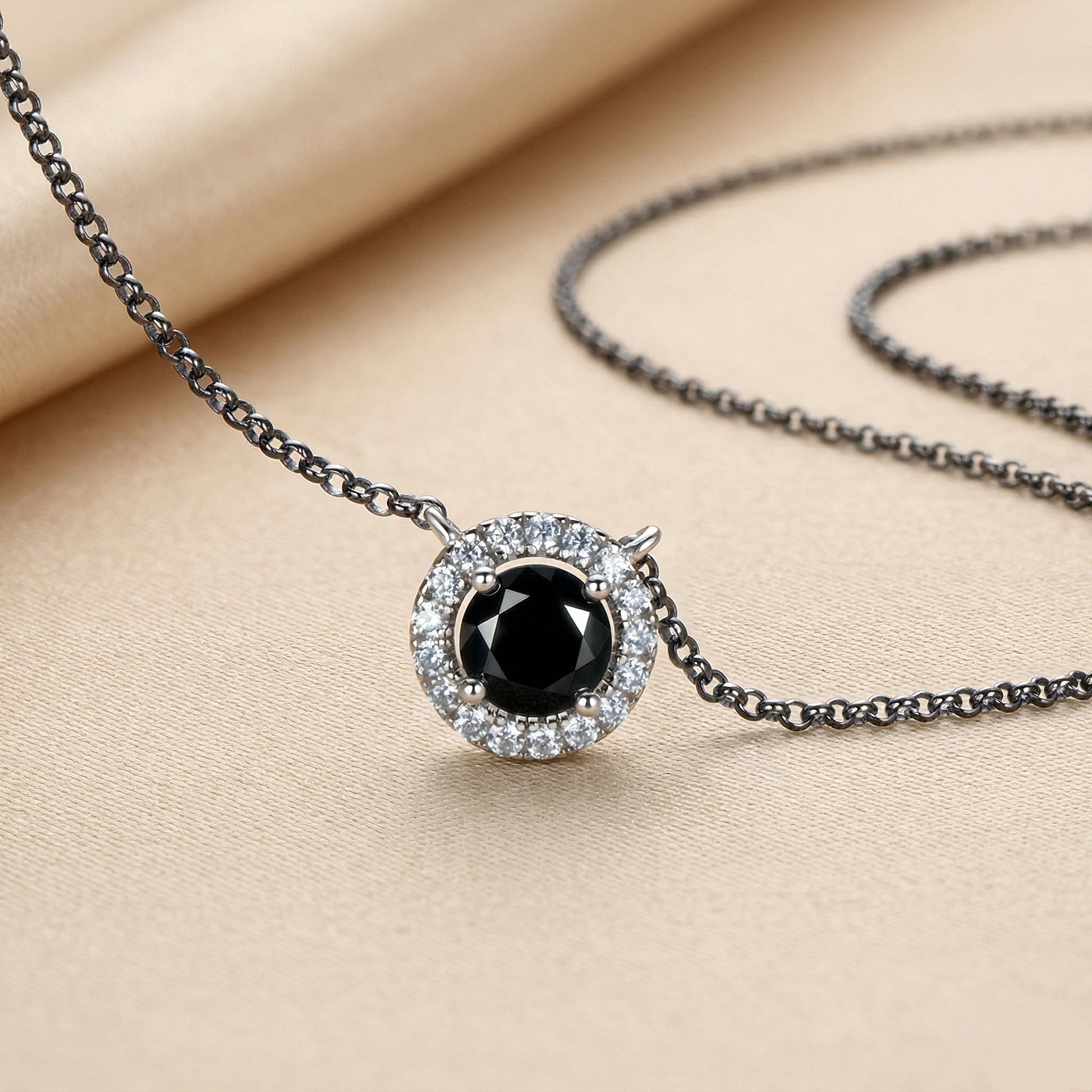 Black moissanite halo pendant necklace close up showing 1ct center stone and cubic zirconia halo in 925 sterling silver - Sensitive Stones