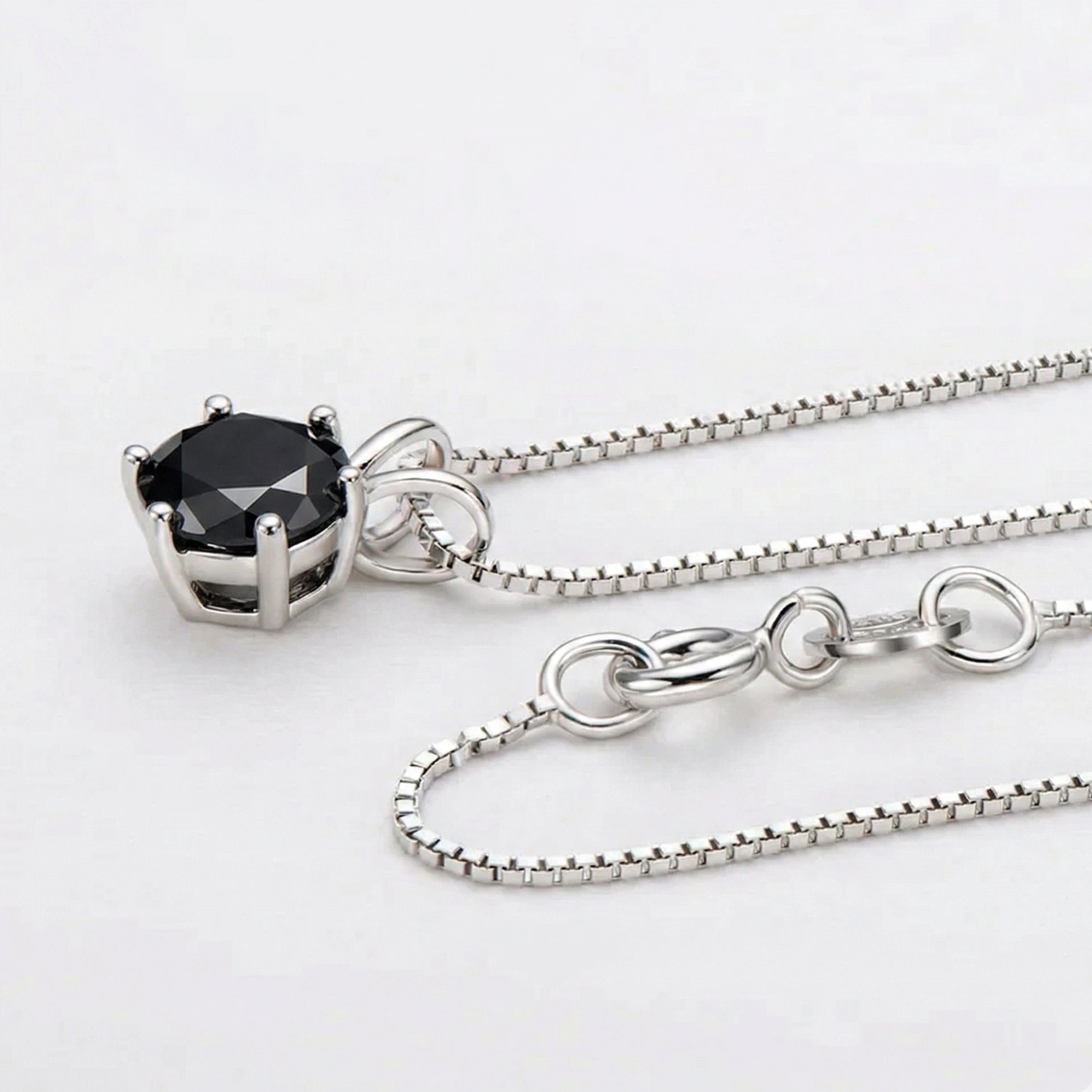 Black moissanite round solitaire pendant necklace in sterling silver with box chain and lobster clasp detail on white background - Sensitive Stones