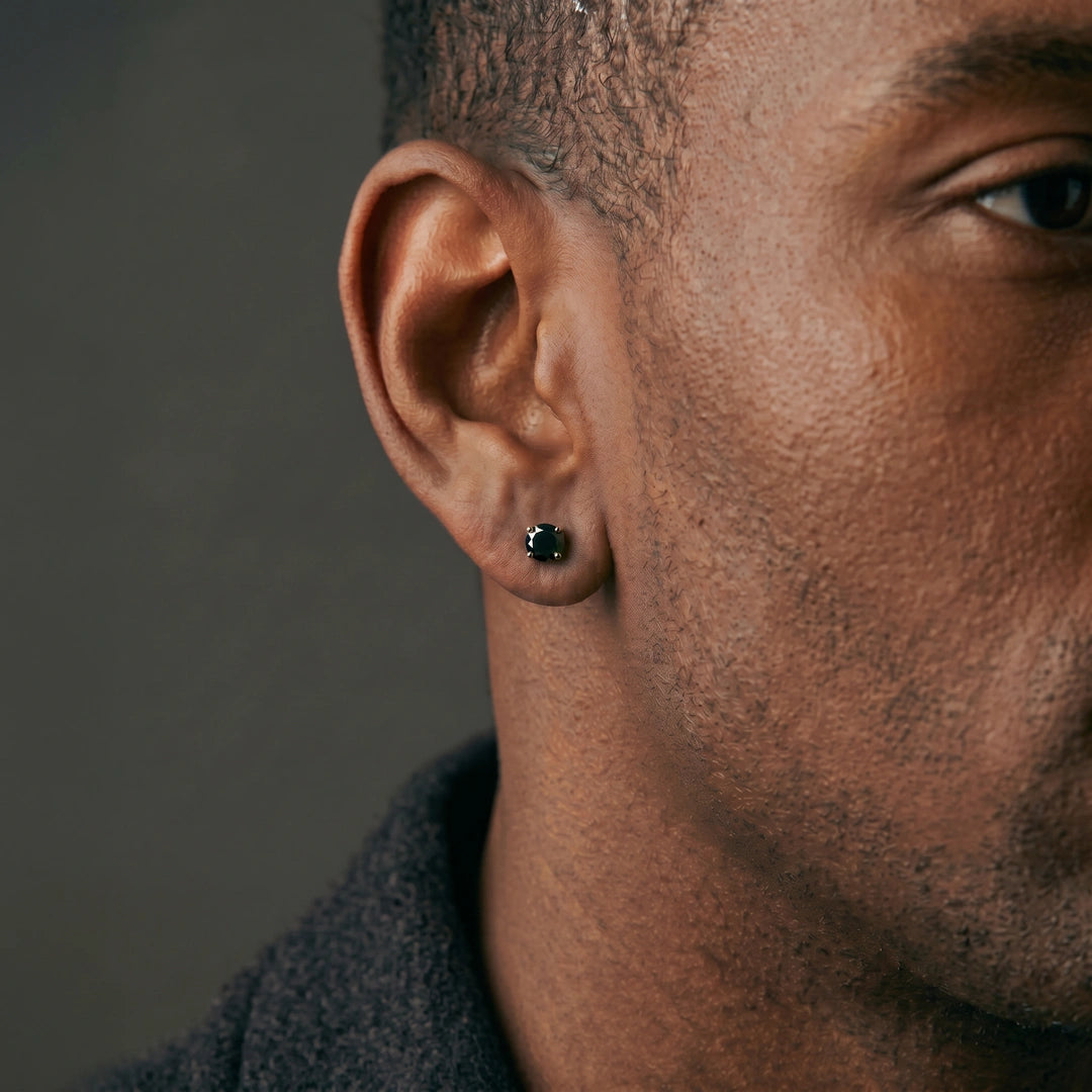 Black moissanite stud earring worn by a man, side profile, round cut in silver - Sensitive Stones