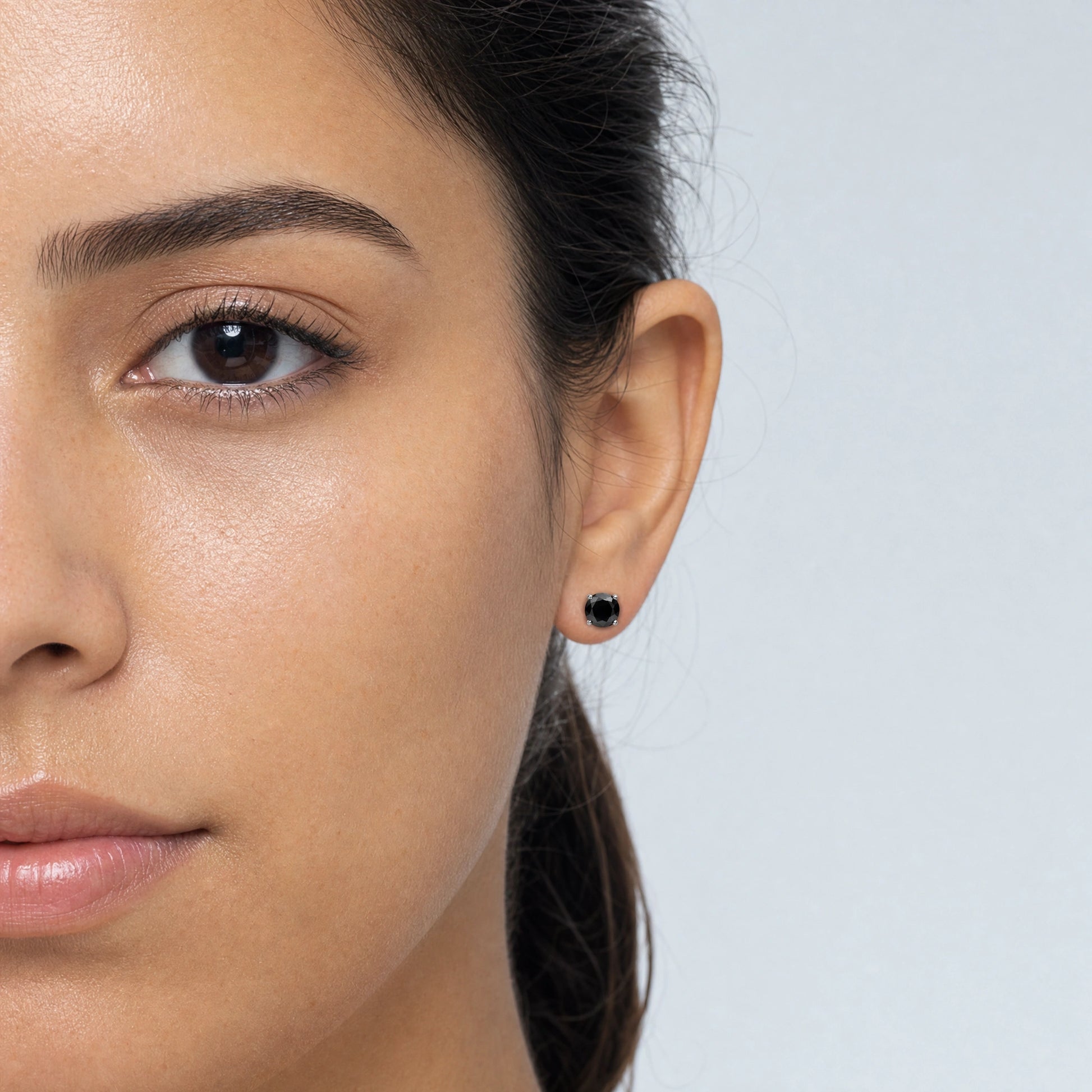 Black moissanite stud earring shown on a woman, round cut in silver, unisex style - Sensitive Stones