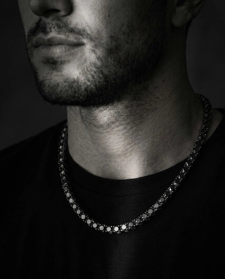 Man wearing 5mm black moissanite tennis necklace in white gold plating with black t-shirt showing unisex versatile design - Sensitive Stones