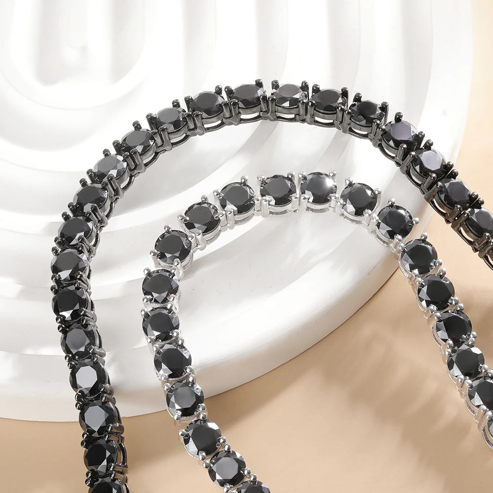 Round-cut black moissanite stones in 4-prong setting tennis necklace on white display - Sensitive Stones