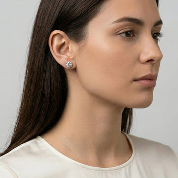 Woman wearing1 carat Blossom Moissanite flower stud earrings in 18K gold plated 925 sterling silver, side profile showing D color VVS1 stone and open blossom basket setting - Sensitive Stones