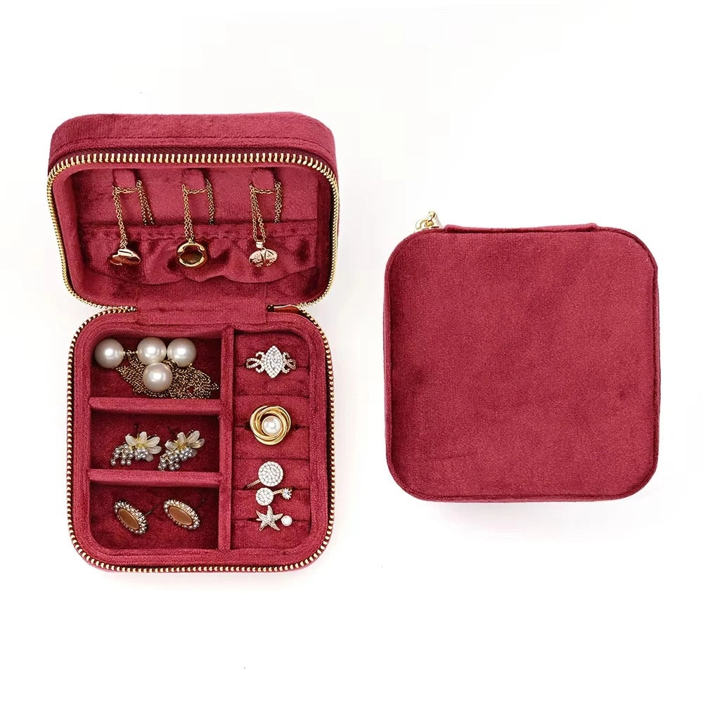 Burgundy velvet travel jewelry box open showing necklace hooks earrings and rings organized inside - Sensitive Stones