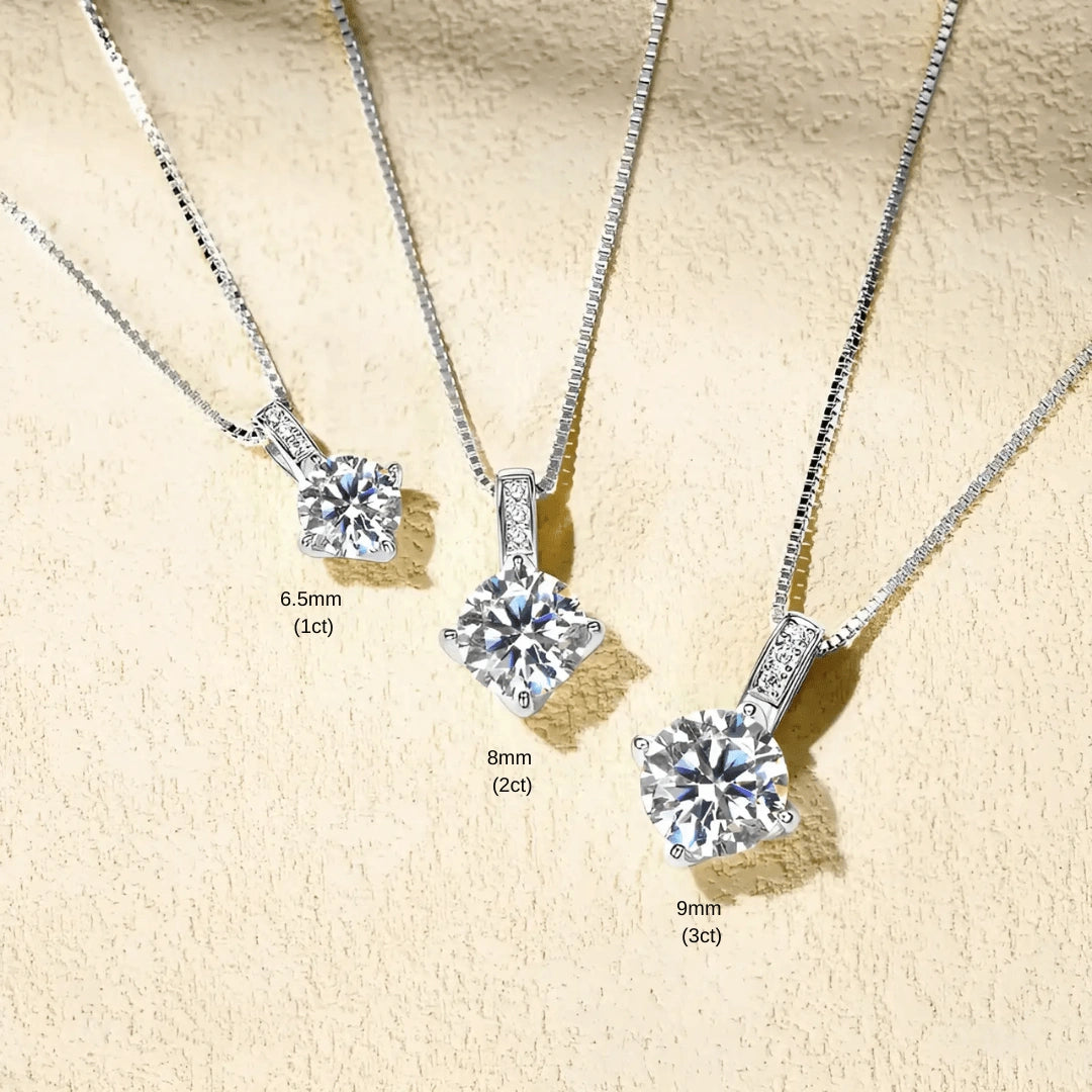 Celeste pavé moissanite solitaire necklace in sterling silver three size variants 1ct 2ct and 3ct lifestyle flat lay on textured surface - Sensitive Stones 