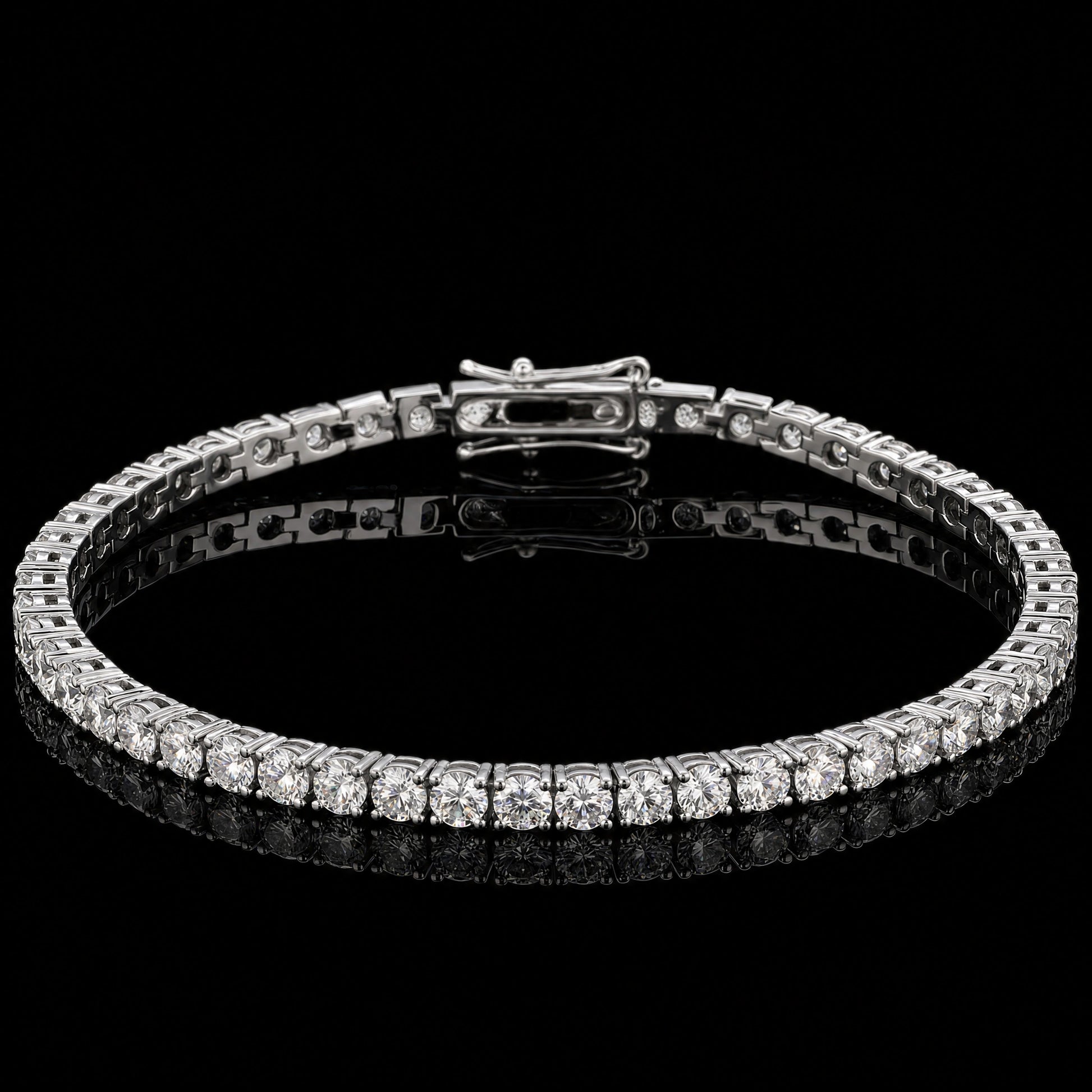 A 3mm classic moissanite tennis bracelet with clear round-cut stones set in 925 sterling silver with white gold finish, featuring a central clasp, displayed on a reflective black surface against a black background - Sensitive Stones