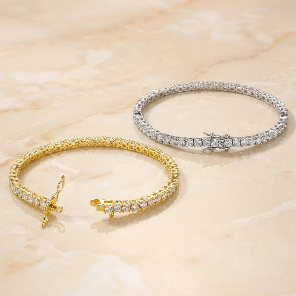 Yellow gold and white gold moissanite tennis bracelets with round brilliant clear stones and box clasp on a marble surface - Sensitive Stones
