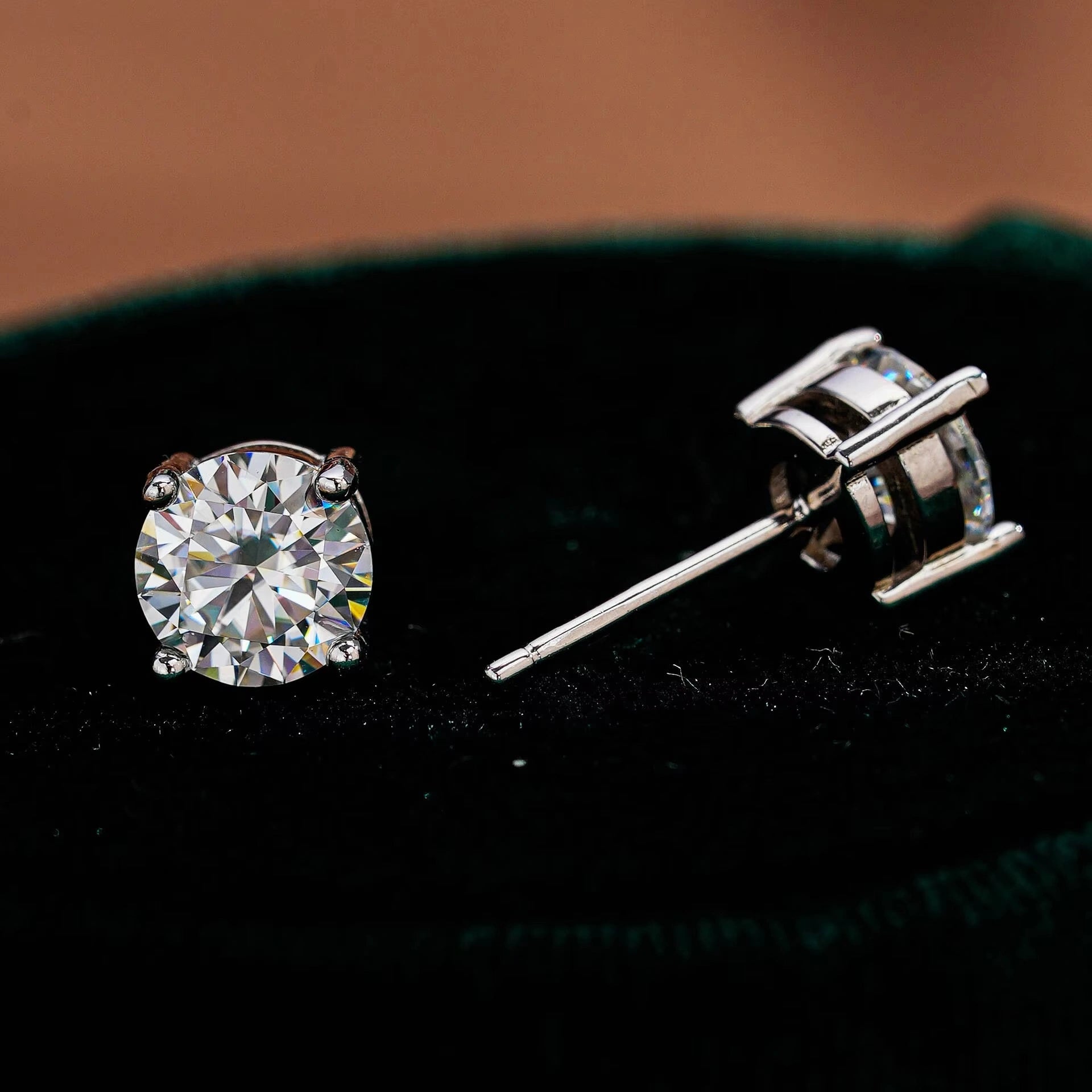 Close up of a pair of round cut moissanite stud earring in 925 sterling silver in a velvet jewelry box – Sensitive Stones