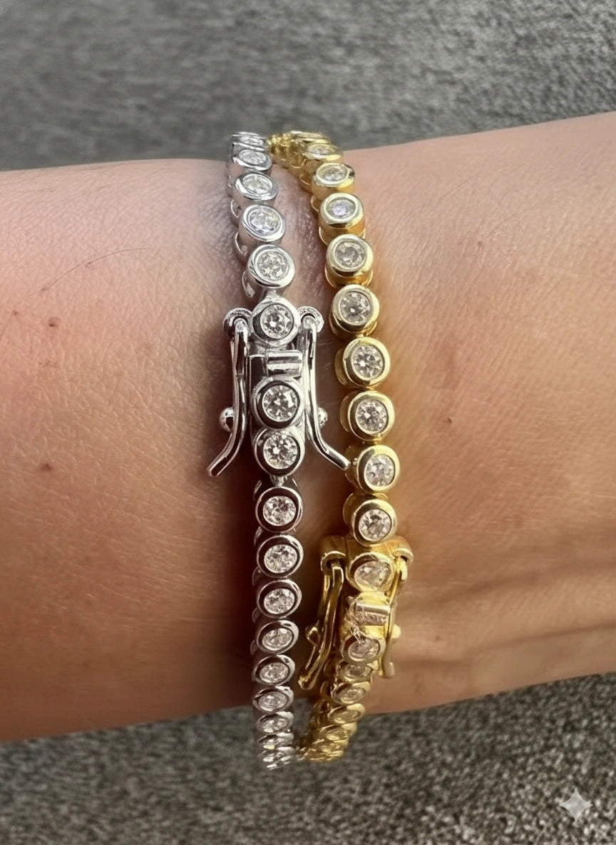 Closeup of silver and gold bezel moissanite tennis bracelets with 2mm D color VVS1 stones in 925 sterling silver, 18K gold plated, showing fire and sparkle - Sensitive Stones