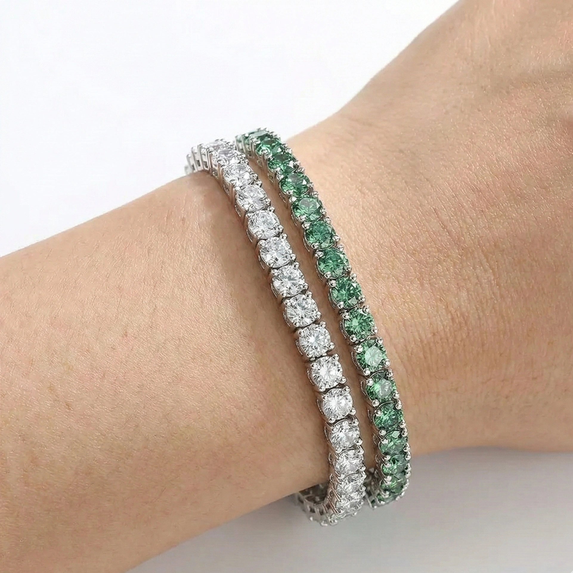 Close wrist shot of stacked green moissanite tennis bracelets illustrating multi-row sparkle – Sensitive Stones