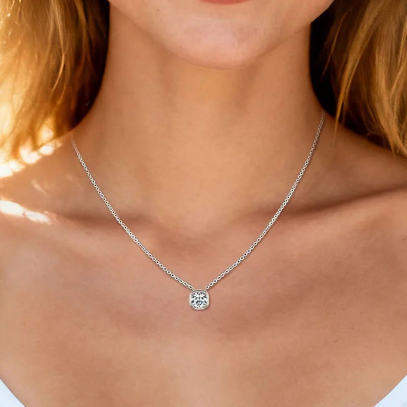Cushion bezel set moissanite pendant necklace in silver worn on model showing pendant drop position - Sensitive Stones