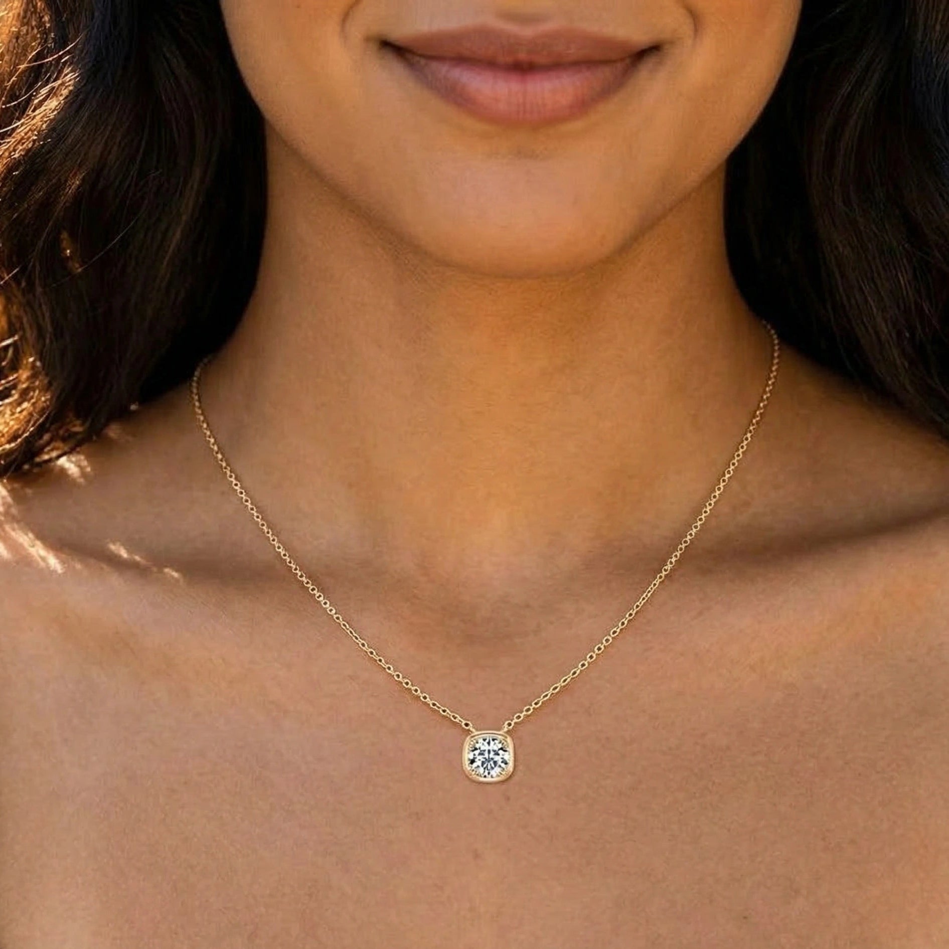 Cushion bezel set moissanite pendant necklace in 18K yellow gold plating worn on model showing pendant drop position - Sensitive Stones
