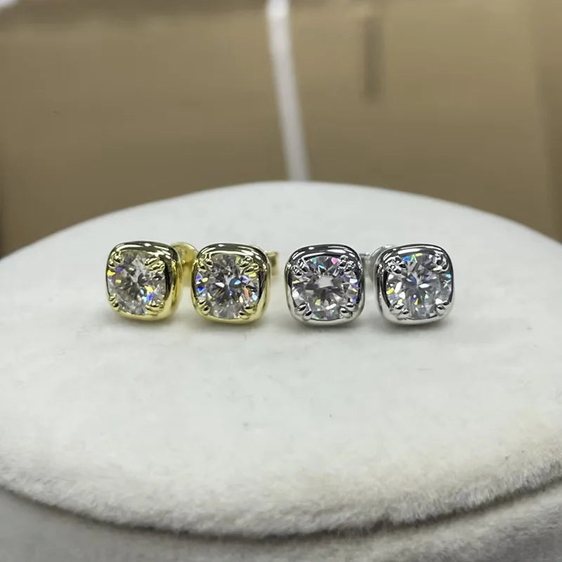 Cushion bezel moissanite stud earrings in 18K gold and 925 sterling silver side by side on white display - Sensitive Stones