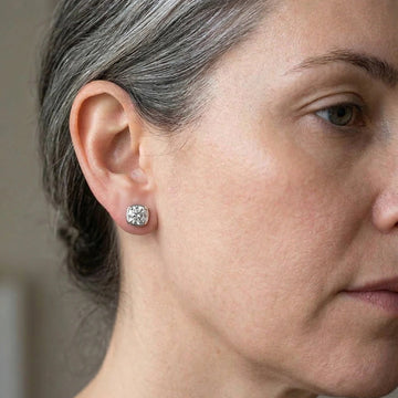 Woman wearing 1ct cushion bezel moissanite stud earrings in 925 sterling silver side profile lifestyle shot - Sensitive Stones