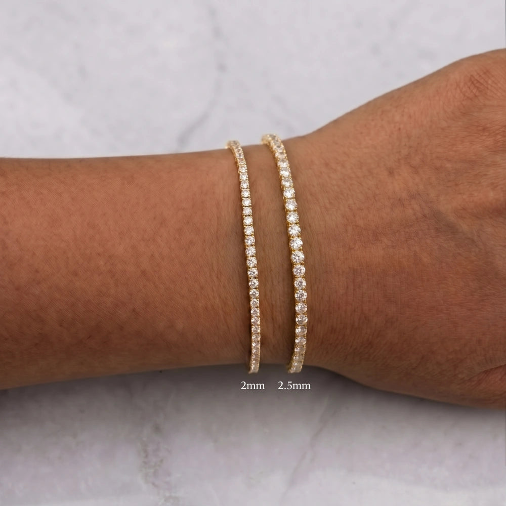 Dainty moissanite tennis bracelet in 18K yellow gold, 2mm and 2.5mm stone sizes shown side by side on the wrist - Sensitive Stones