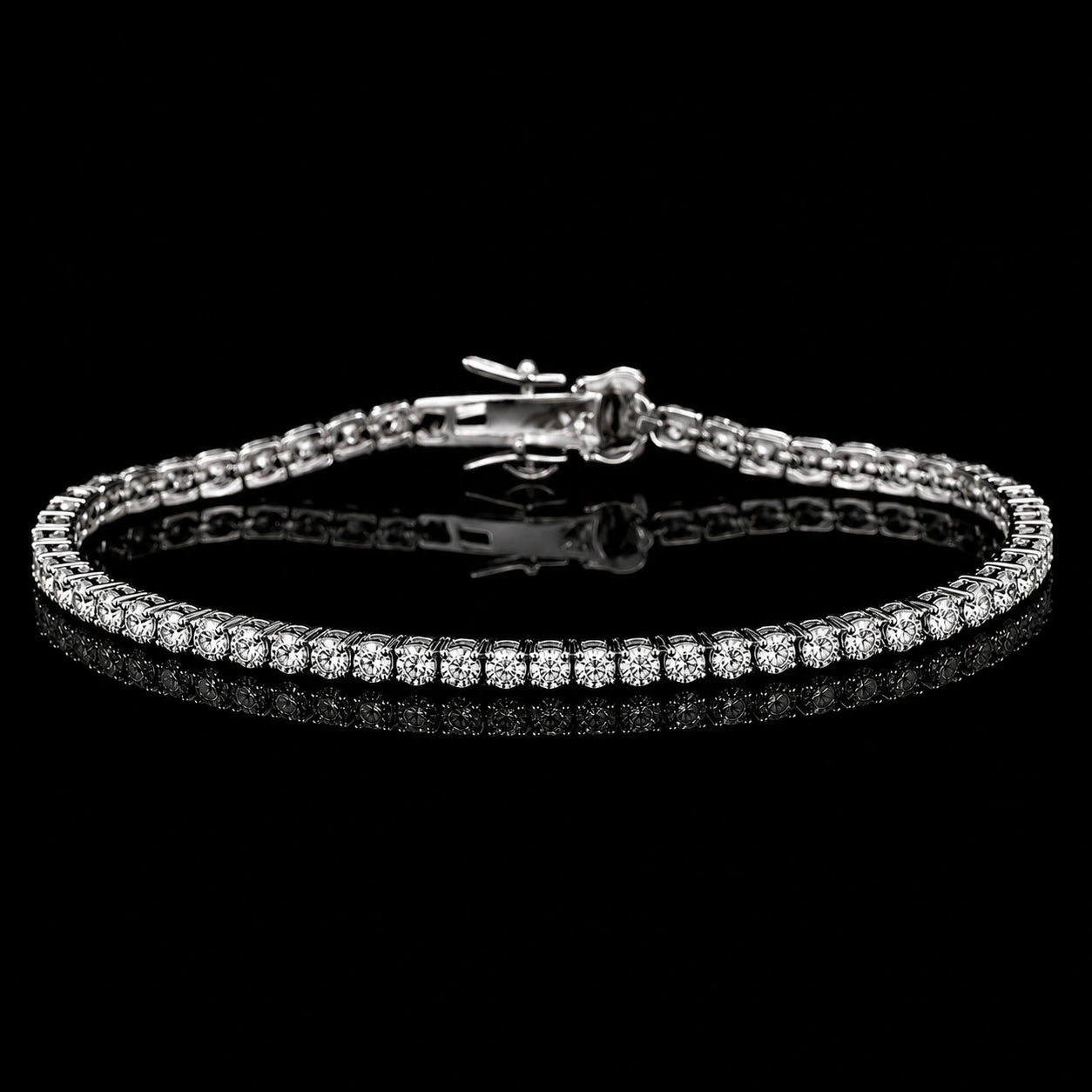 A 2mm dainty moissanite tennis bracelet with clear round-cut stones set in 925 sterling silver with white gold finish, featuring a central clasp, displayed on a reflective black surface against a black background - Sensitive Stones