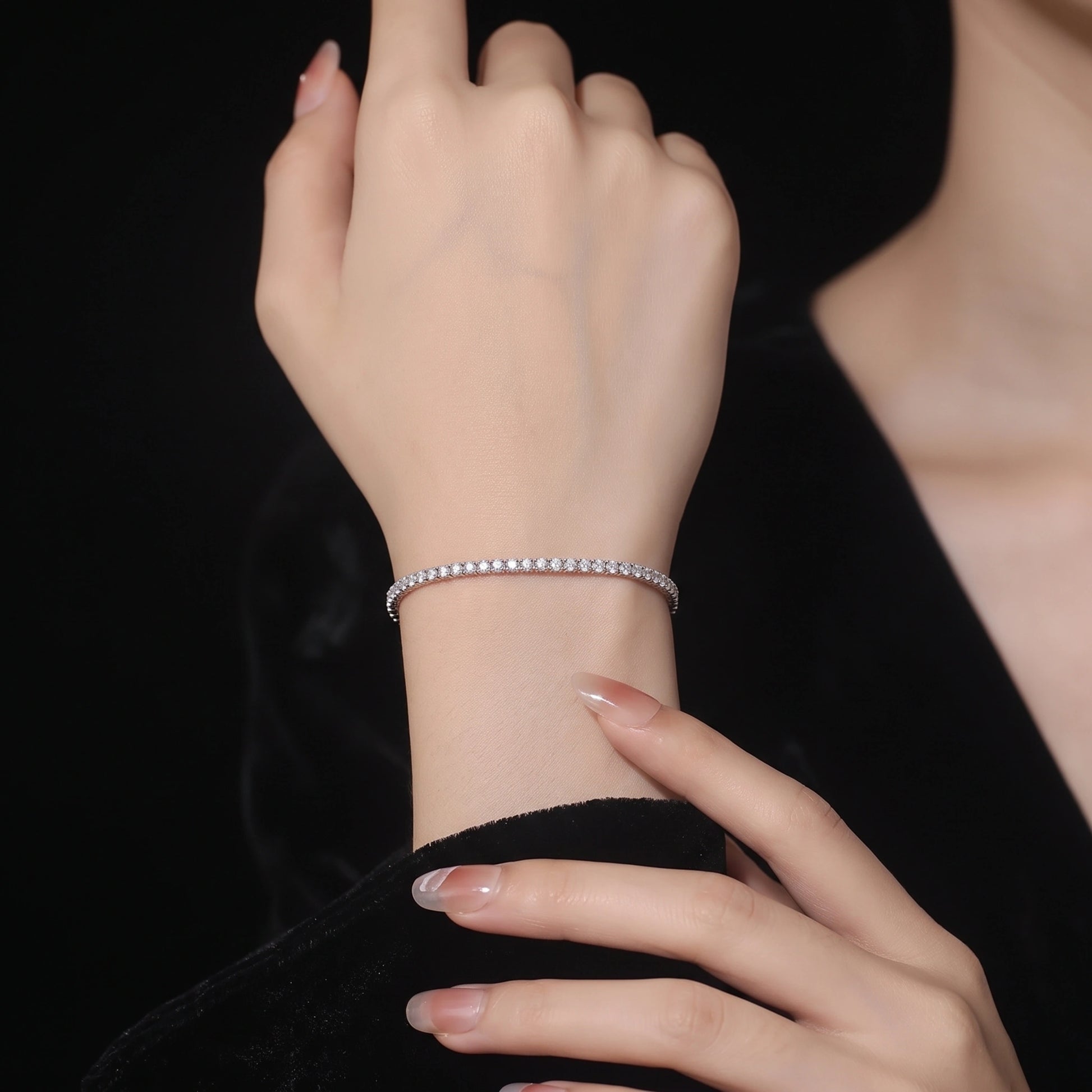 Woman wearing the 2mm dainty moissanite tennis bracelet in 18K white gold - Sensitive Stones