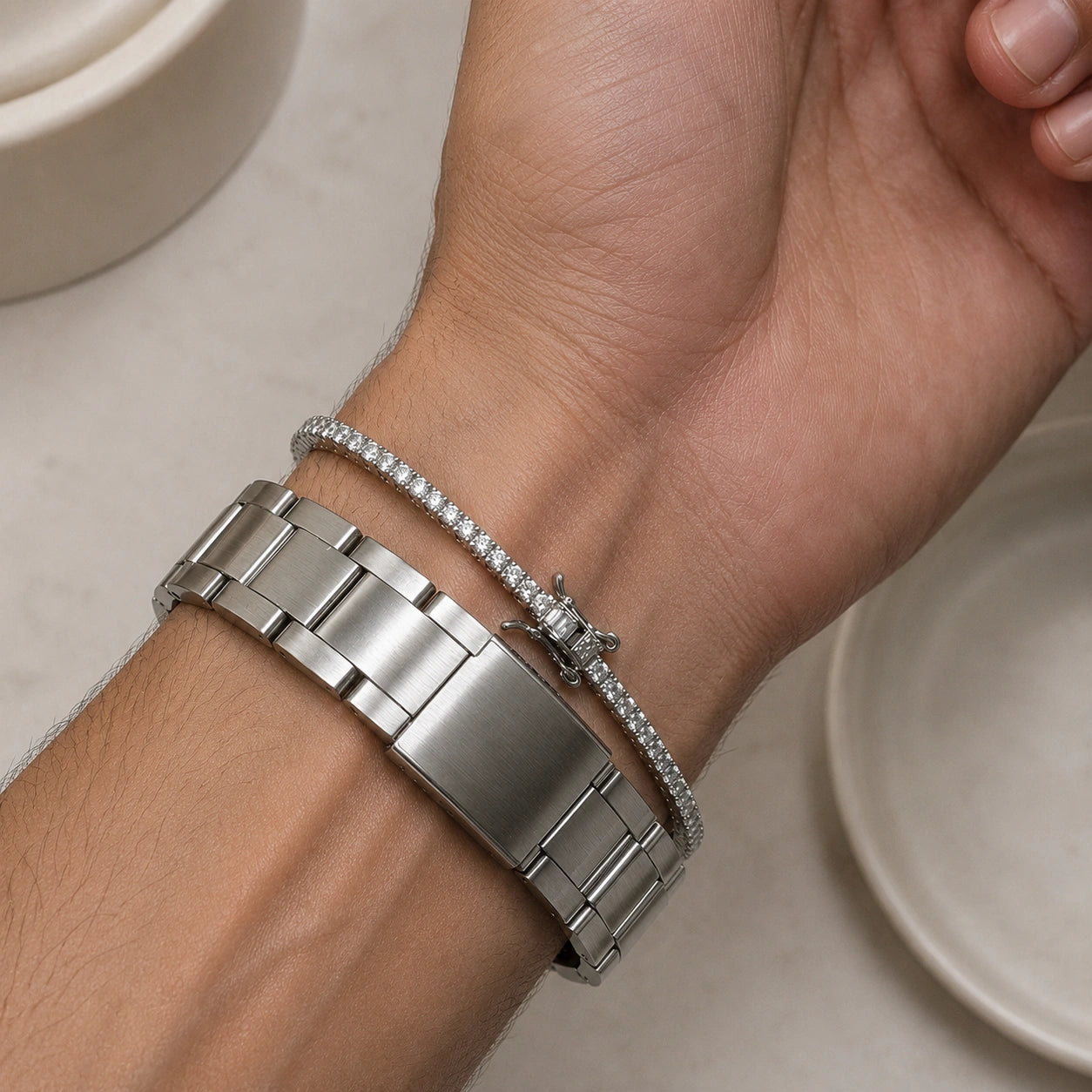 Man wearing the 2.5mm dainty moissanite tennis bracelet stacked beside a watch - Sensitive Stones
