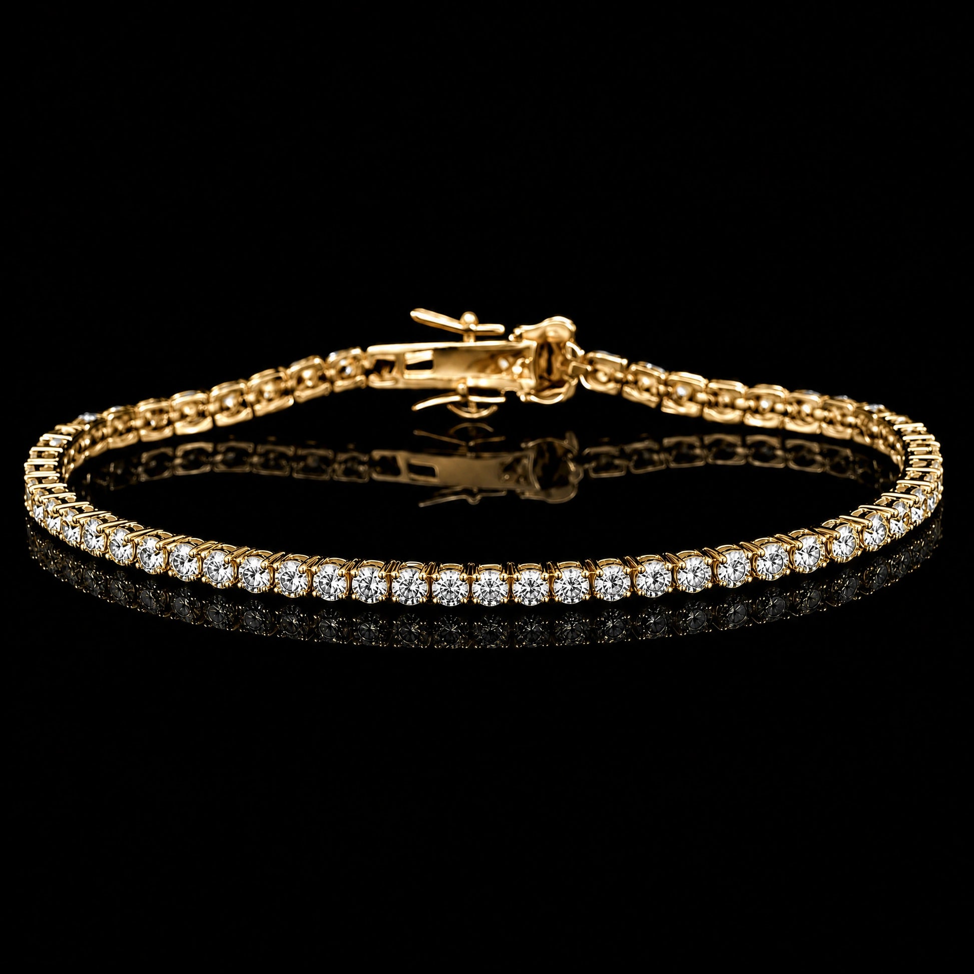 A 2mm dainty moissanite tennis bracelet with clear round-cut stones set in 925 sterling silver with yellow gold finish, featuring a central clasp, displayed on a reflective black surface against a black background - Sensitive Stones