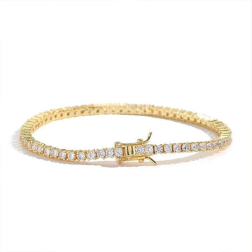 A 18k gold plated tennis bracelet with a row of clear stones on one side and a gold clasp, shown on a white background - Sensitive Stones