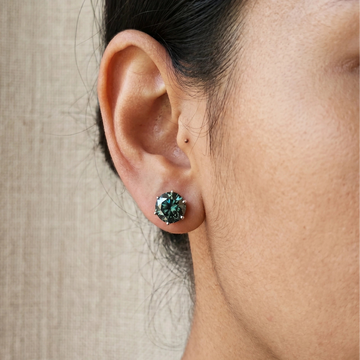 2ct Dark green moissanite solitaire stud earring in 6 prong 925 silver worn on a woman's ear - Sensitive Stones