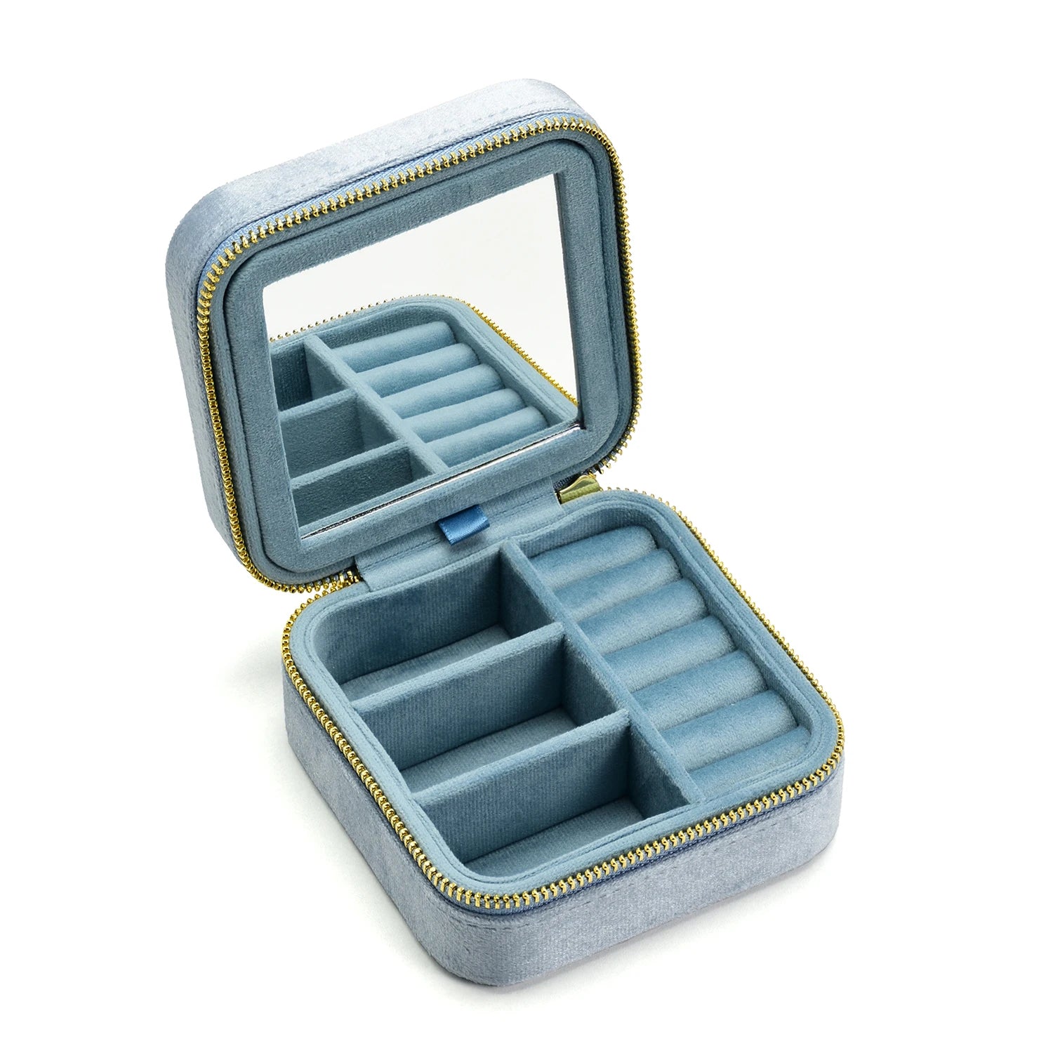 Dusty blue velvet travel jewelry box open showing ring rolls and earring compartments with built-in mirror - Sensitive Stones