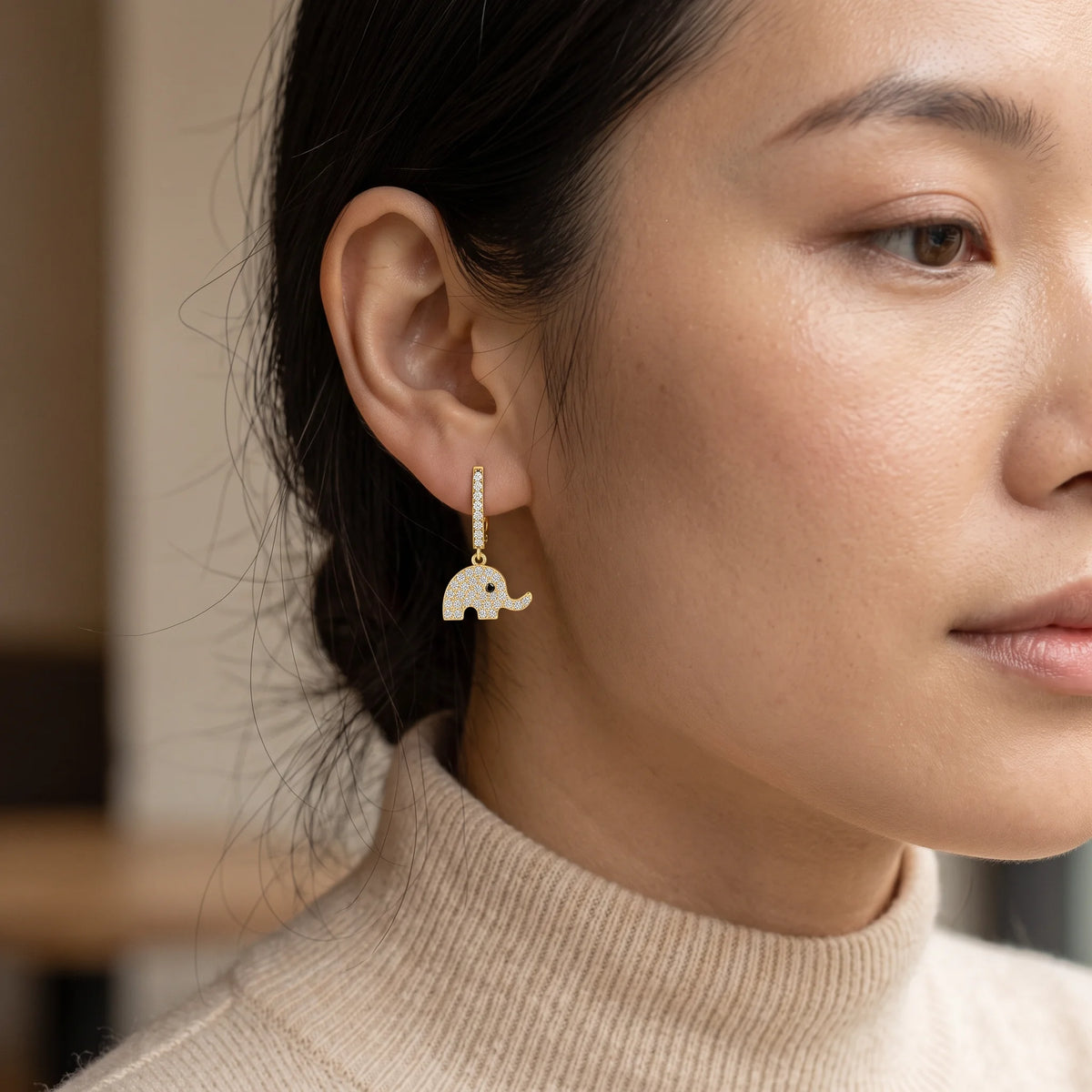 Elephant dangle moissanite earring in 14K gold filled shown on a model for scale - Sensitive Stones