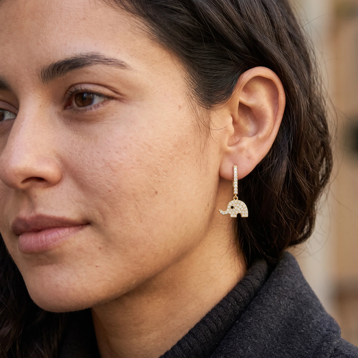 Elephant dangle moissanite earring in 14K gold filled worn on the ear, the charm hanging free below the lobe - Sensitive Stones