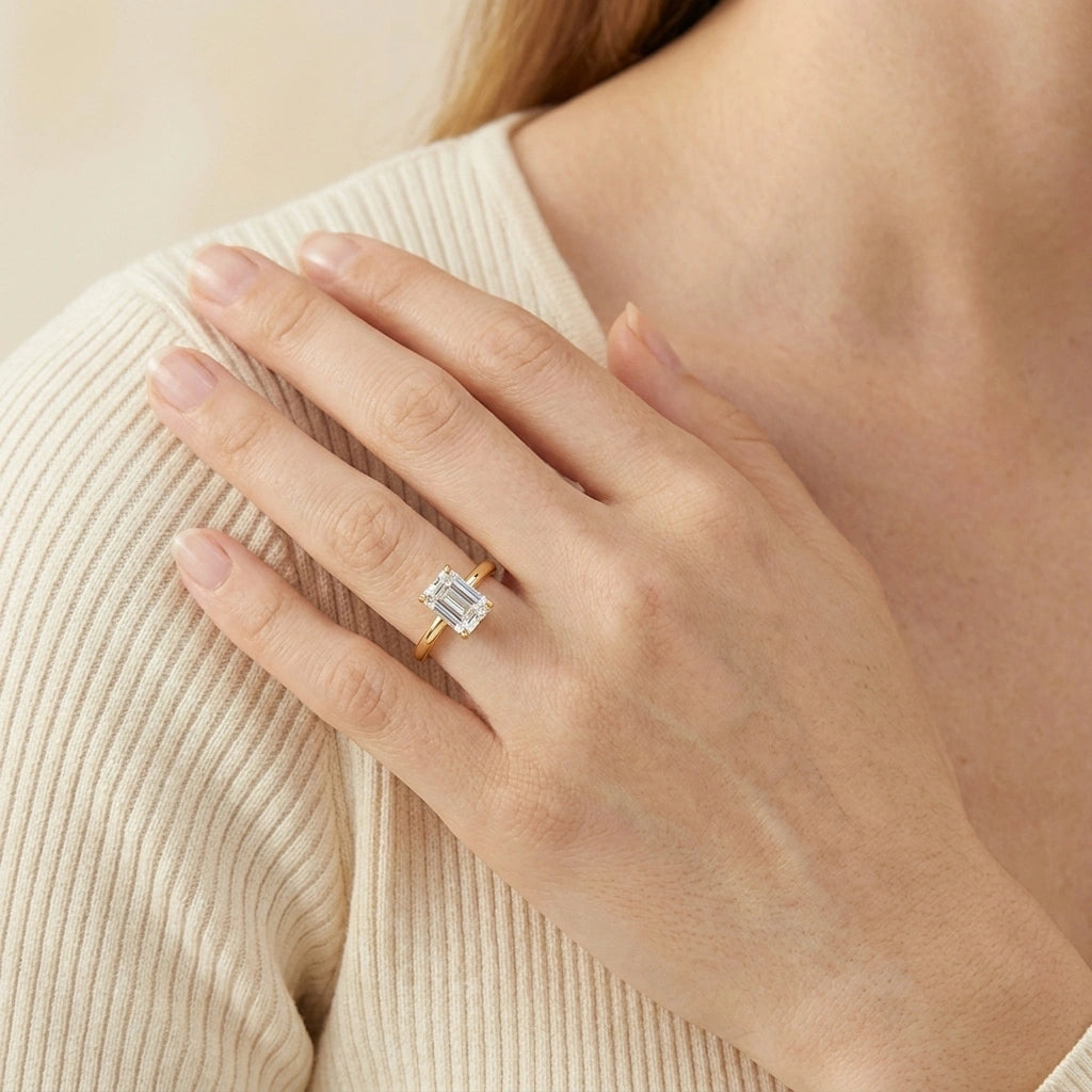 Woman wearing emerald cut moissanite engagement ring in 14K gold filled - Sensitive Stones