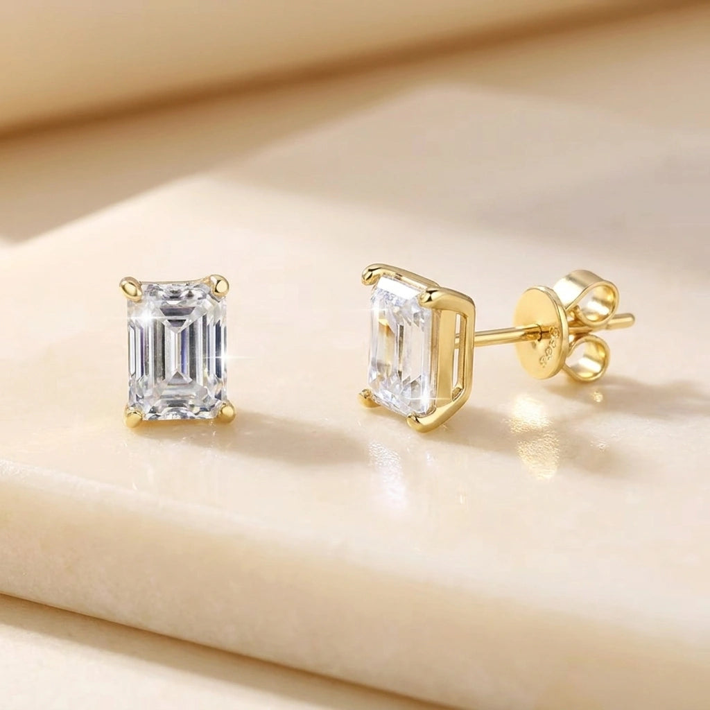 Emerald cut moissanite stud earrings in yellow gold showing the step-cut facets - Sensitive Stones