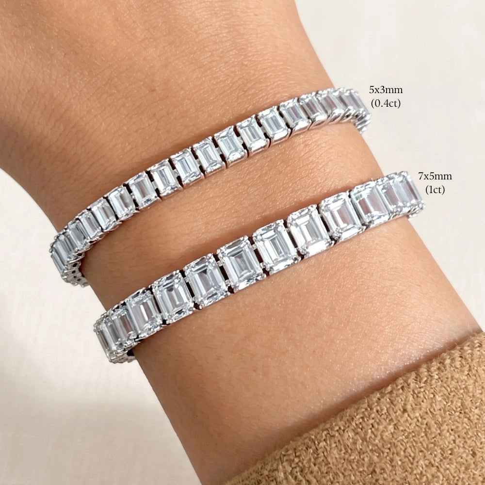Emerald cut moissanite tennis bracelet size comparison, 5x3mm and 7x5mm stones worn together on the wrist in 925 sterling silver - Sensitive Stones