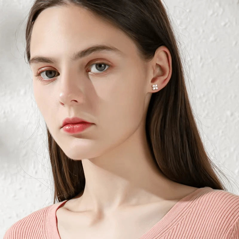 Four leaf clover moissanite stud earrings in 925 sterling silver and yellow gold plating worn on model with D color VVS1 moissanite – Sensitive Stones