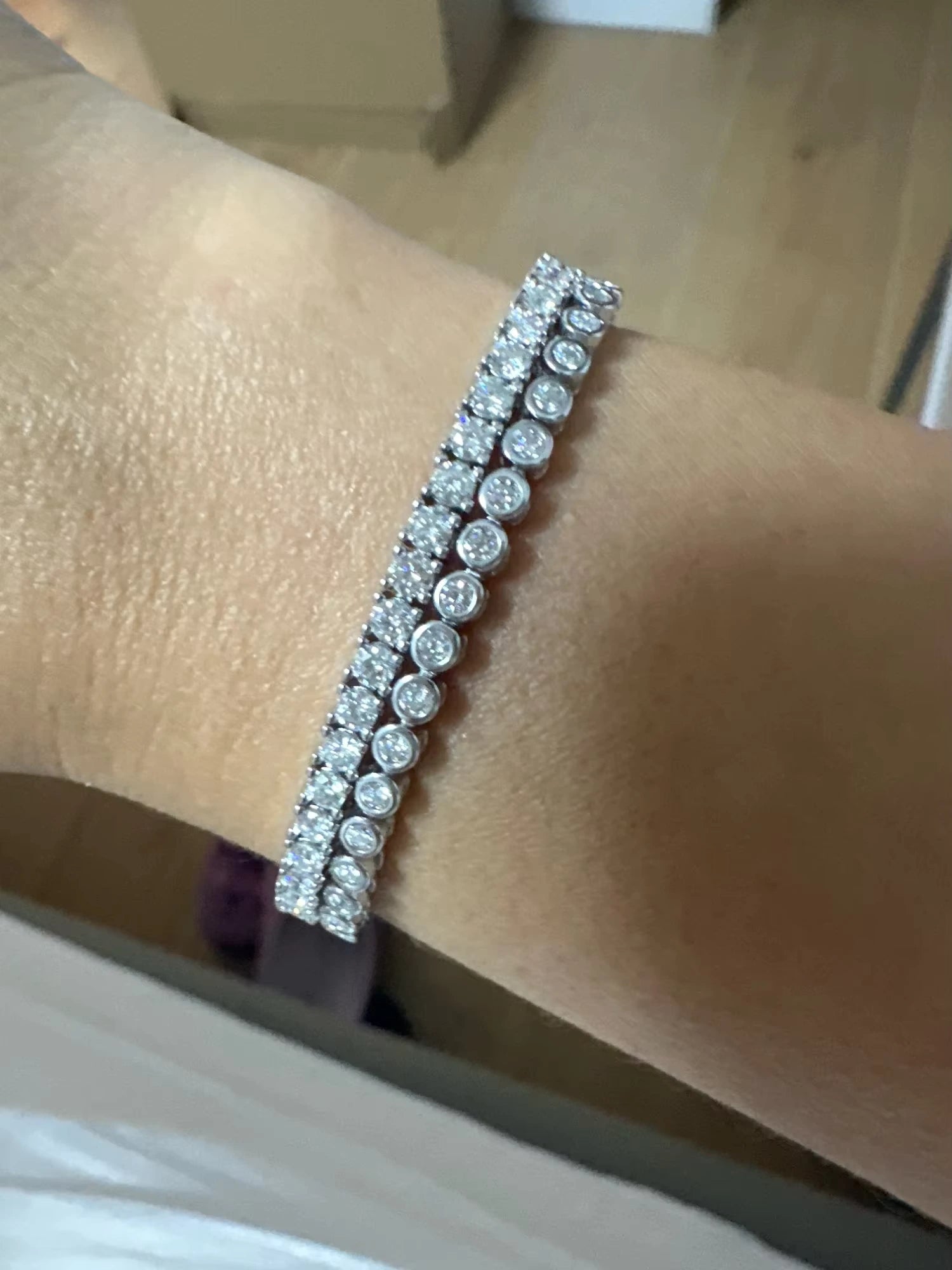 Double stack of full moissanite tennis bracelets, featuring solitaire and bezel-set designs.