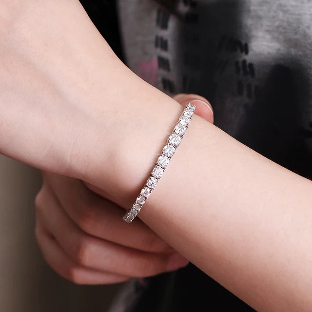Close-up of a model’s bare wrist wearing a white moissanite tennis bracelet – Sensitive Stones