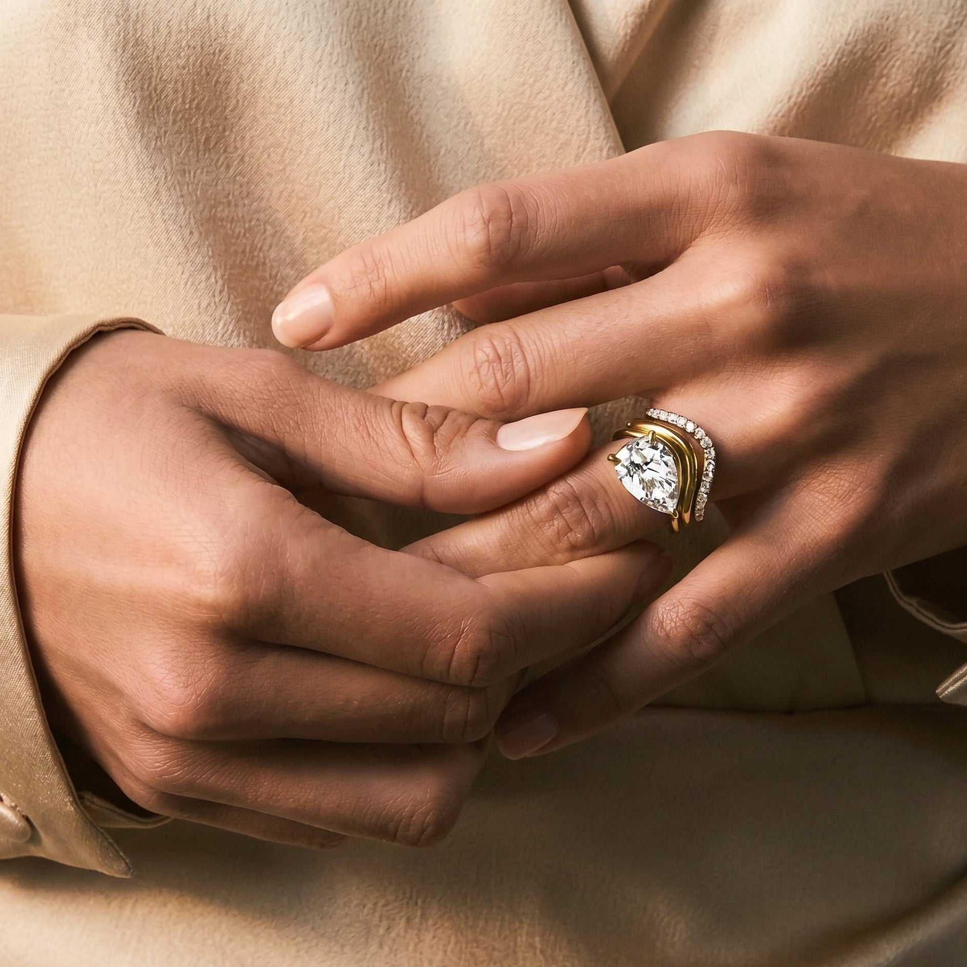 Gold filled wave stacking ring layered with moissanite statement ring on model's finger - Sensitive Stones