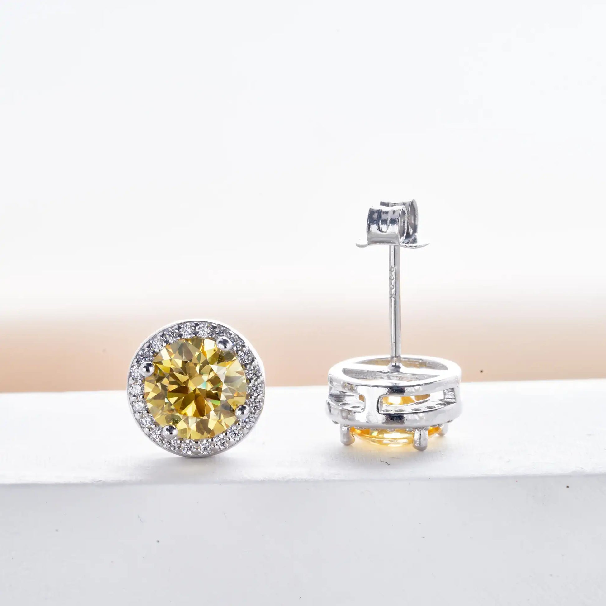 Pair of golden yellow moissanite halo stud earring showing front and butterfly back detail in 925 silver - Sensitive Stones