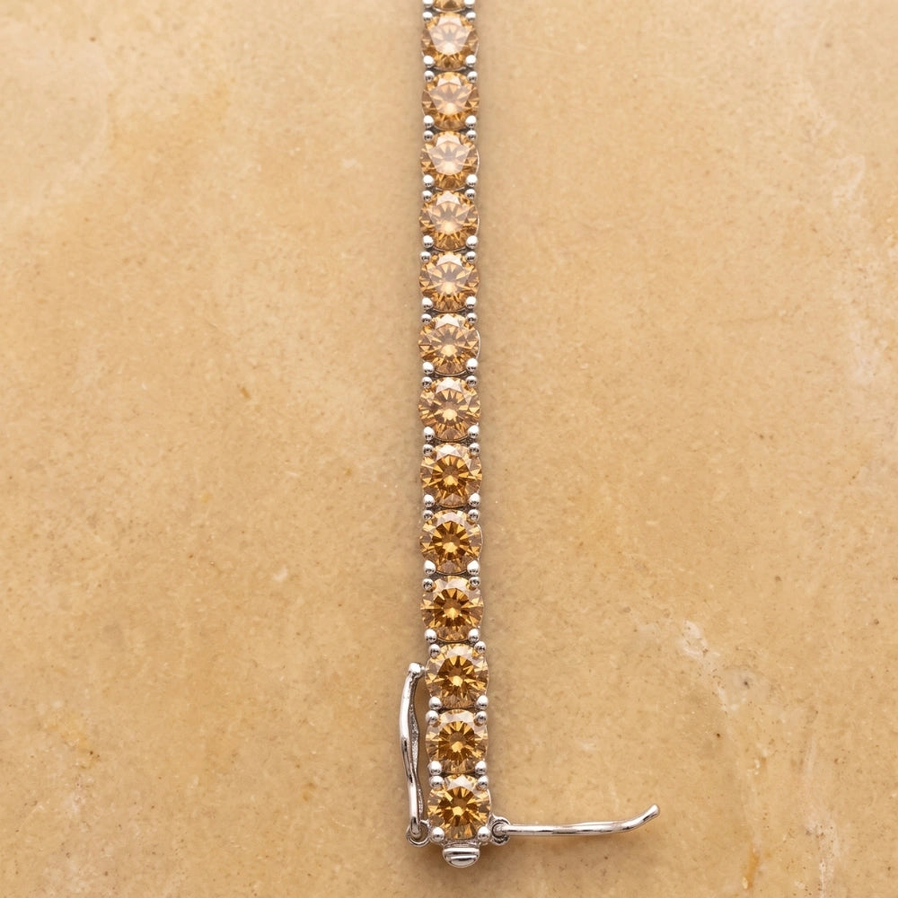 Golden yellow moissanite tennis bracelet in white gold plated sterling silver, displayed with clasp open - Sensitive Stones 