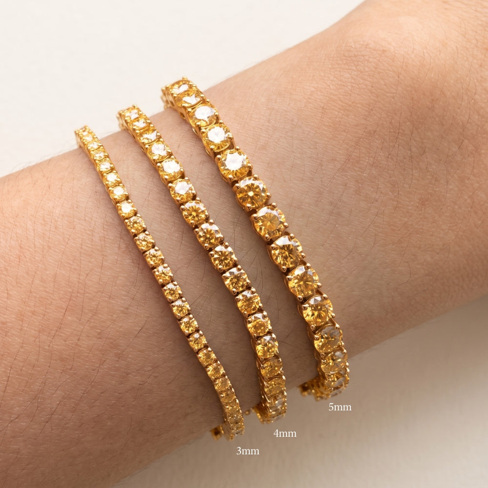 Size comparison of 3mm, 4mm and 5mm golden yellow moissanite tennis bracelets in 18K yellow gold plated sterling silver worn on a wrist - Sensitive Stones