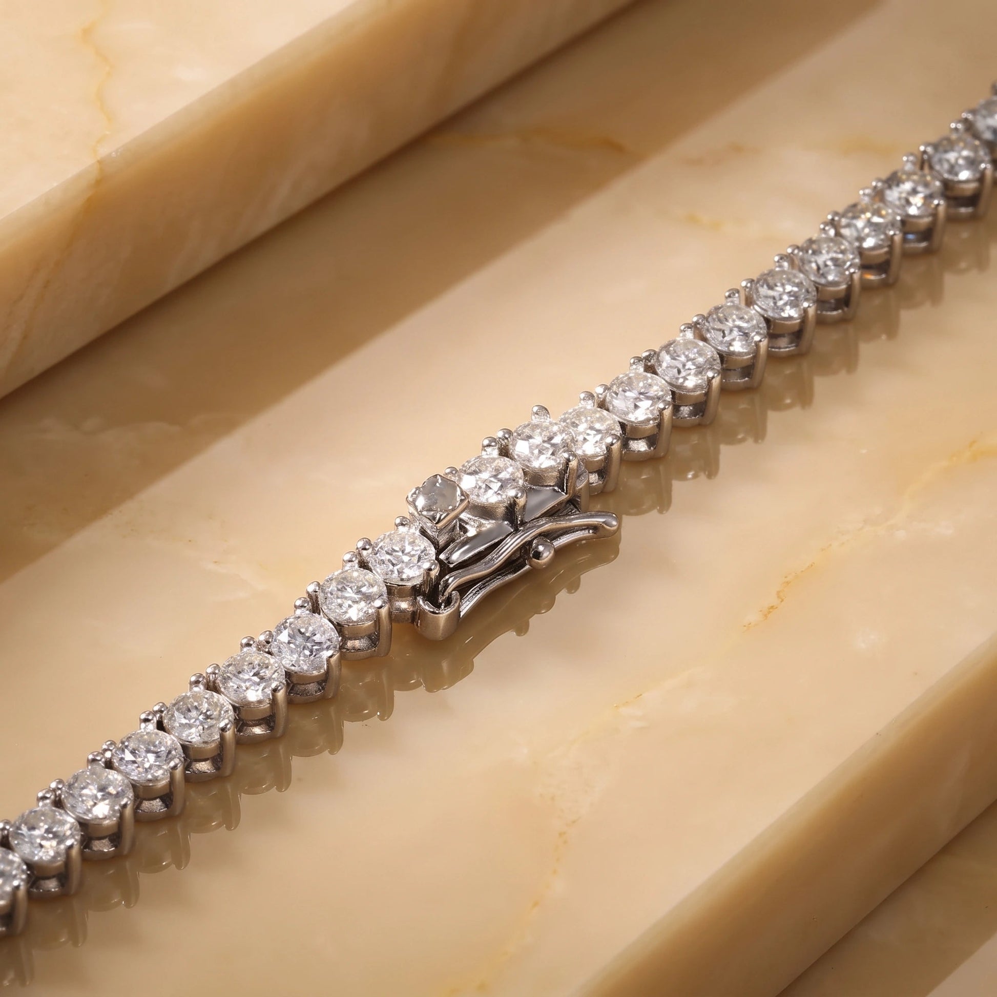 Close-up of the box clasp and safety catch on a graduated moissanite tennis necklace in 925 sterling silver