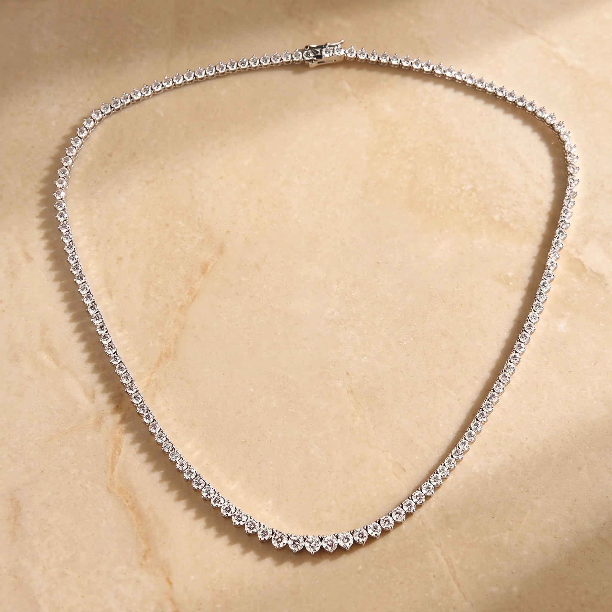 Full length of a graduated moissanite tennis necklace in 925 sterling silver with D color VVS1 round brilliant stones