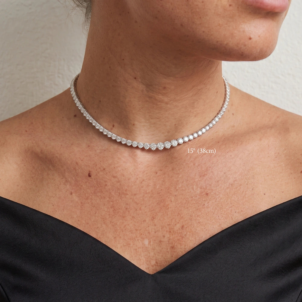 Graduated moissanite tennis necklace 15 inches worn on the neck, stones rising from the nape to the largest at the centre front