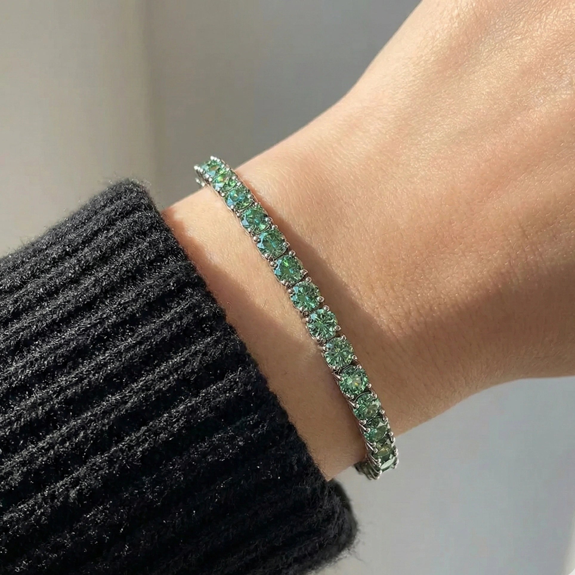 Green moissanite tennis bracelet in 925 silver worn on wrist - Sensitive Stones