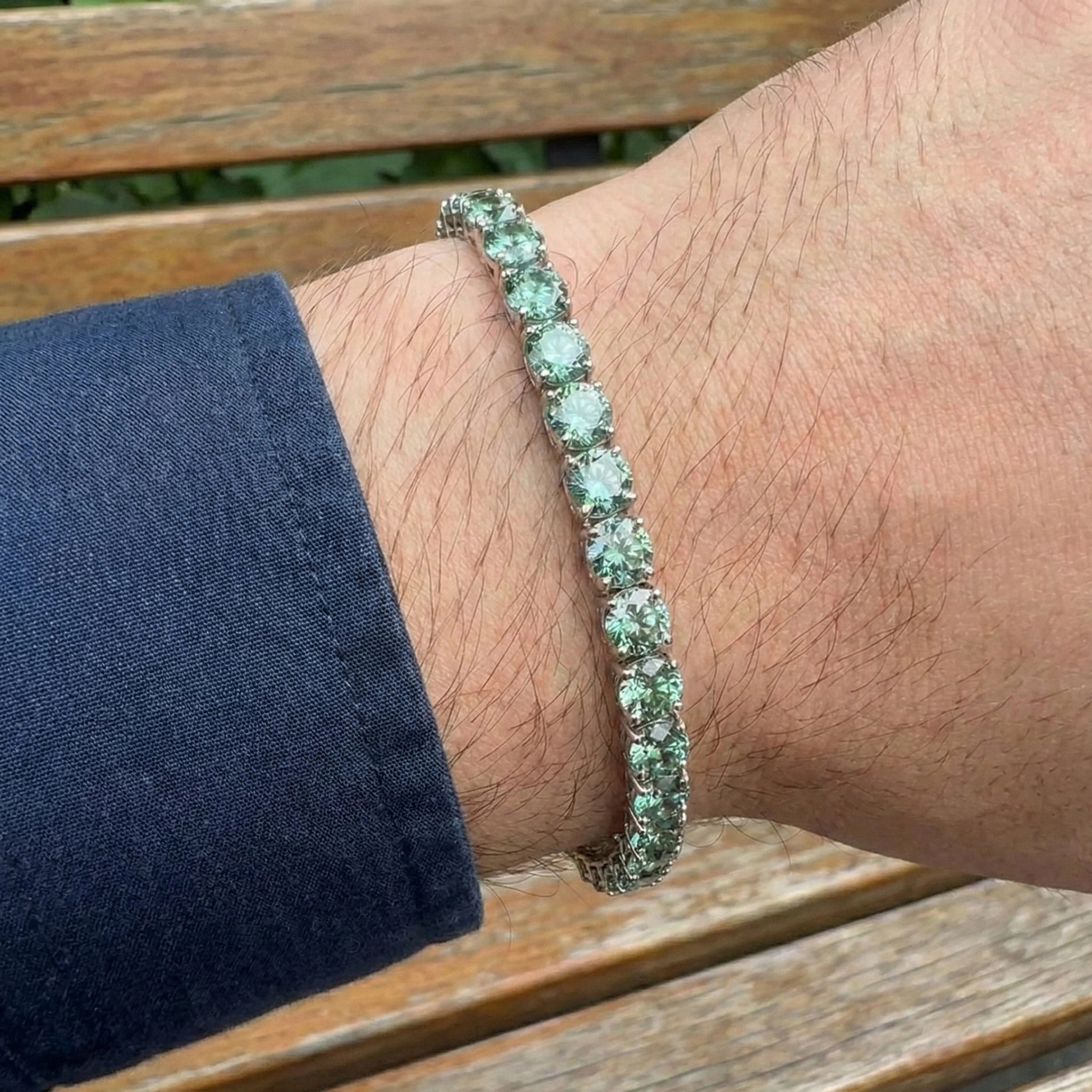 5mm green moissanite tennis bracelet on man's wrist in sterling silver with 4-prong setting - Sensitive Stones